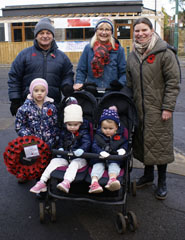Photo 3  - 2023 Normanby Remembrance Day Service - Mr and Mrs Conroy with Sophie and Lucy (in pushchair) - sisters of Phoebe (holding wreath from Normanby Primary School)