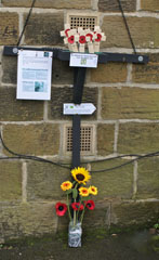 Photo 10  - British Legion Memorial Walk - Commemorative vase with poppies and a sunflower placed at the foot of the Memorial